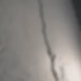 Detailed view of a drywall seam crack before repair