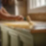 Brushing off old paint from kitchen cabinet